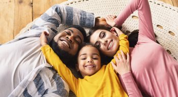 family-evening-multiracial-family-daughter-hugging-GHEWGPU.jpg