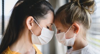 mother-and-child-with-face-masks-indoors-at-home-c-R6CGLQB.jpg
