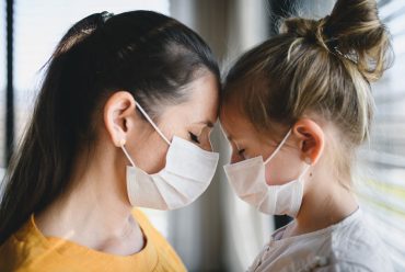 mother-and-child-with-face-masks-indoors-at-home-c-R6CGLQB.jpg