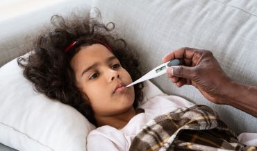 world-pandemic-sick-little-girl-with-high-fever-an-XSA2L9F.jpg